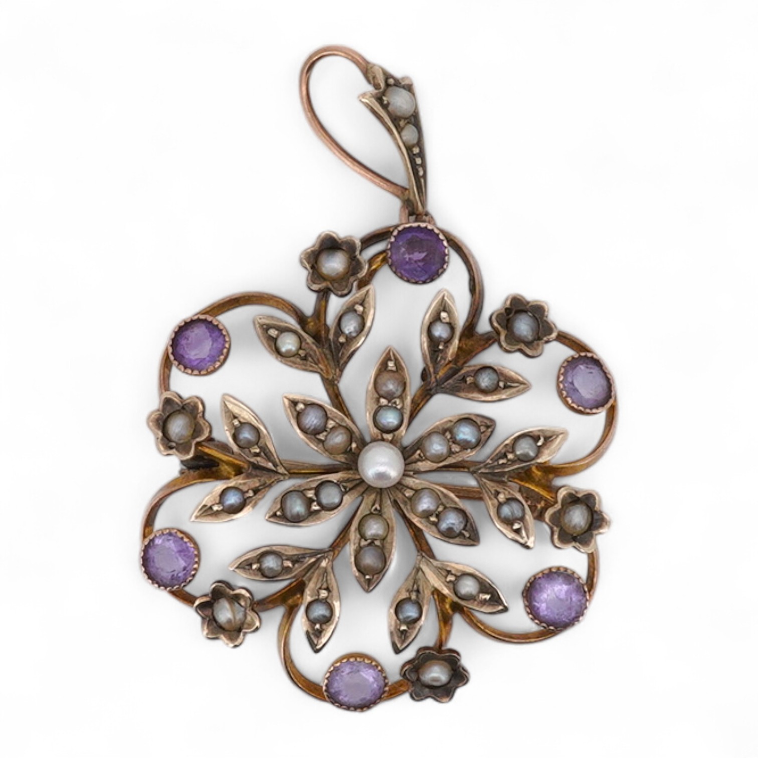 An Edwardian seed pearl and amethyst pendant, early 20th century, of floral design, set with seed pearls and circular-cut amethysts, mounted in gold, length 4cm including bail, brooch fitting, stamped 9ct and H&GB, Condi